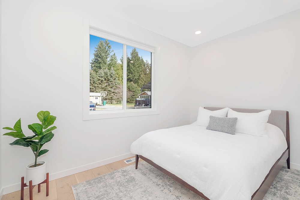 white bed linen on bed