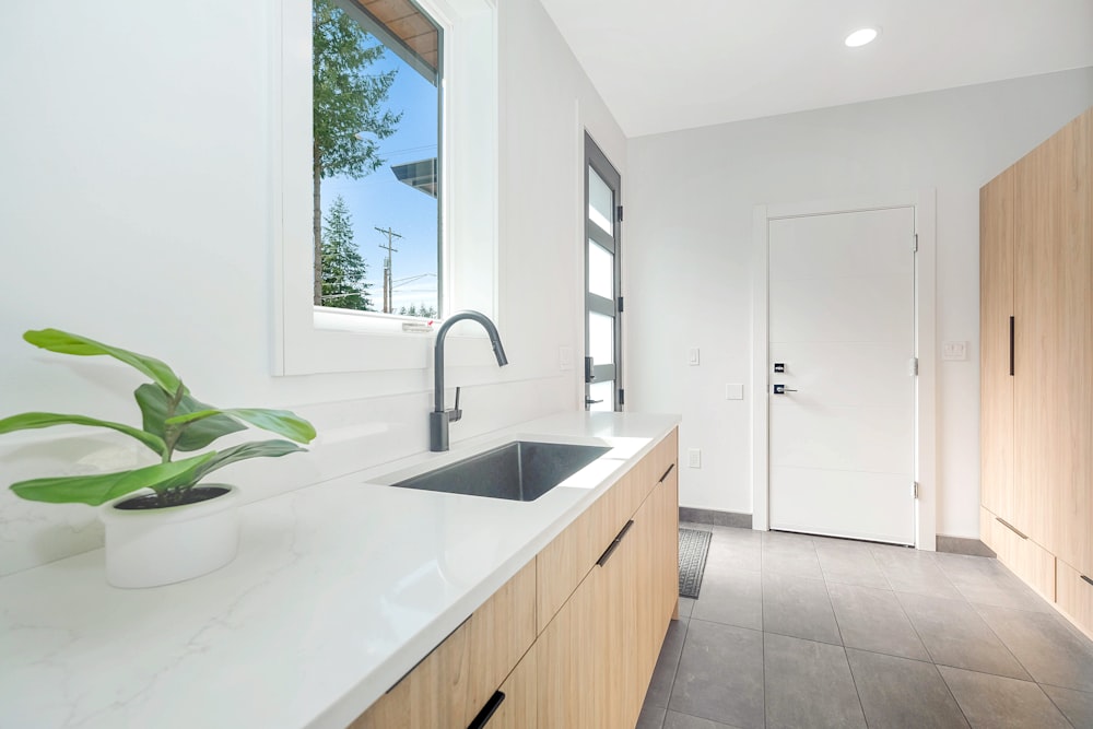 white ceramic sink with stainless steel faucet