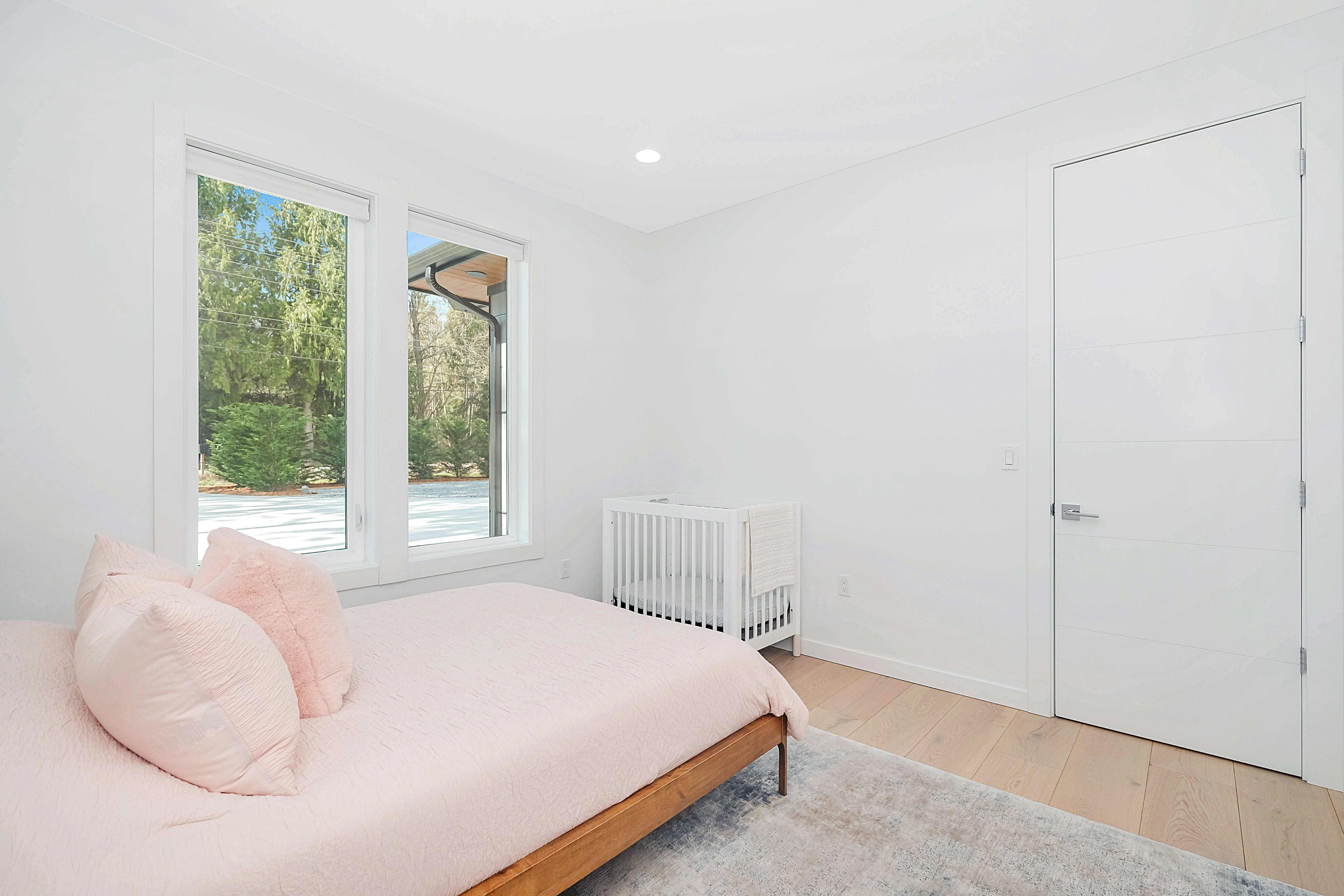 white wooden bed frame beside white wall