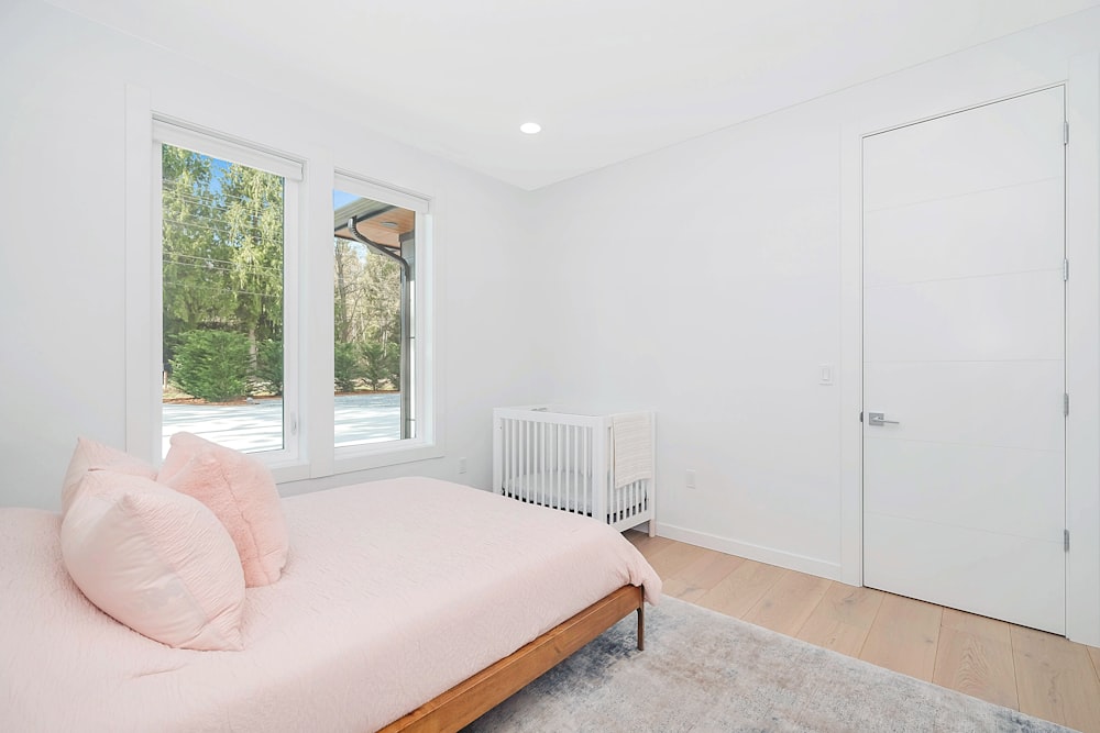 white wooden bed frame beside white wall