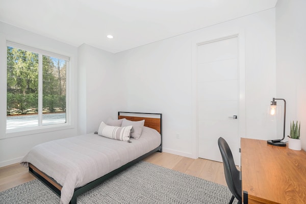 white bed pillow on bed