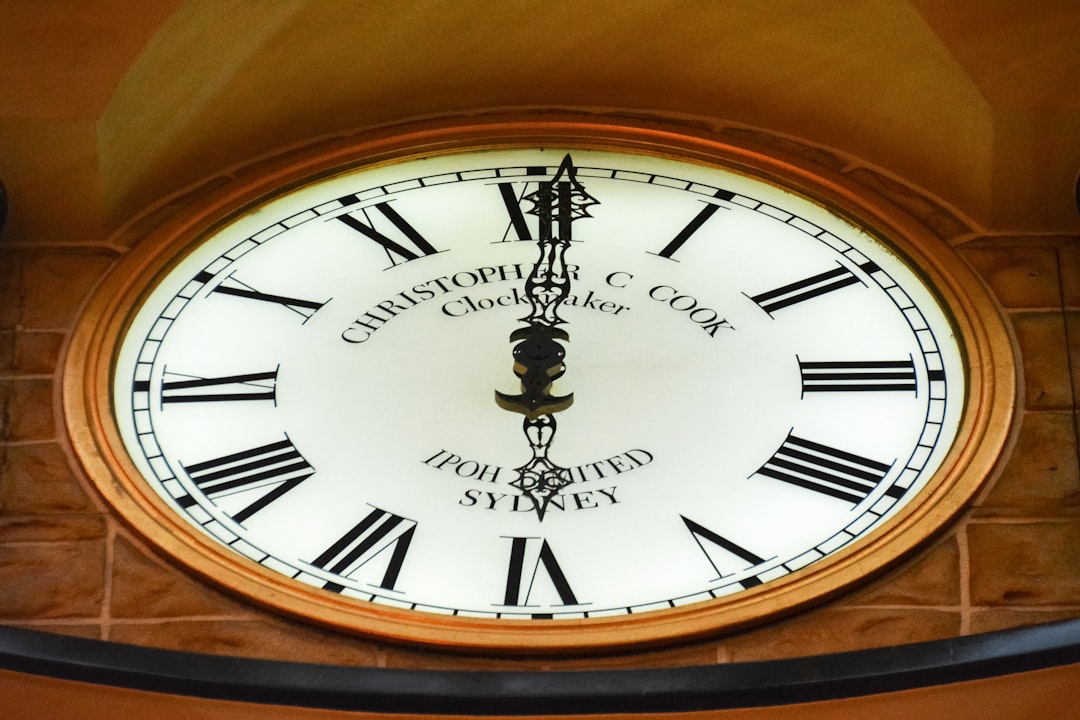 brown wooden framed analog clock at 10 00