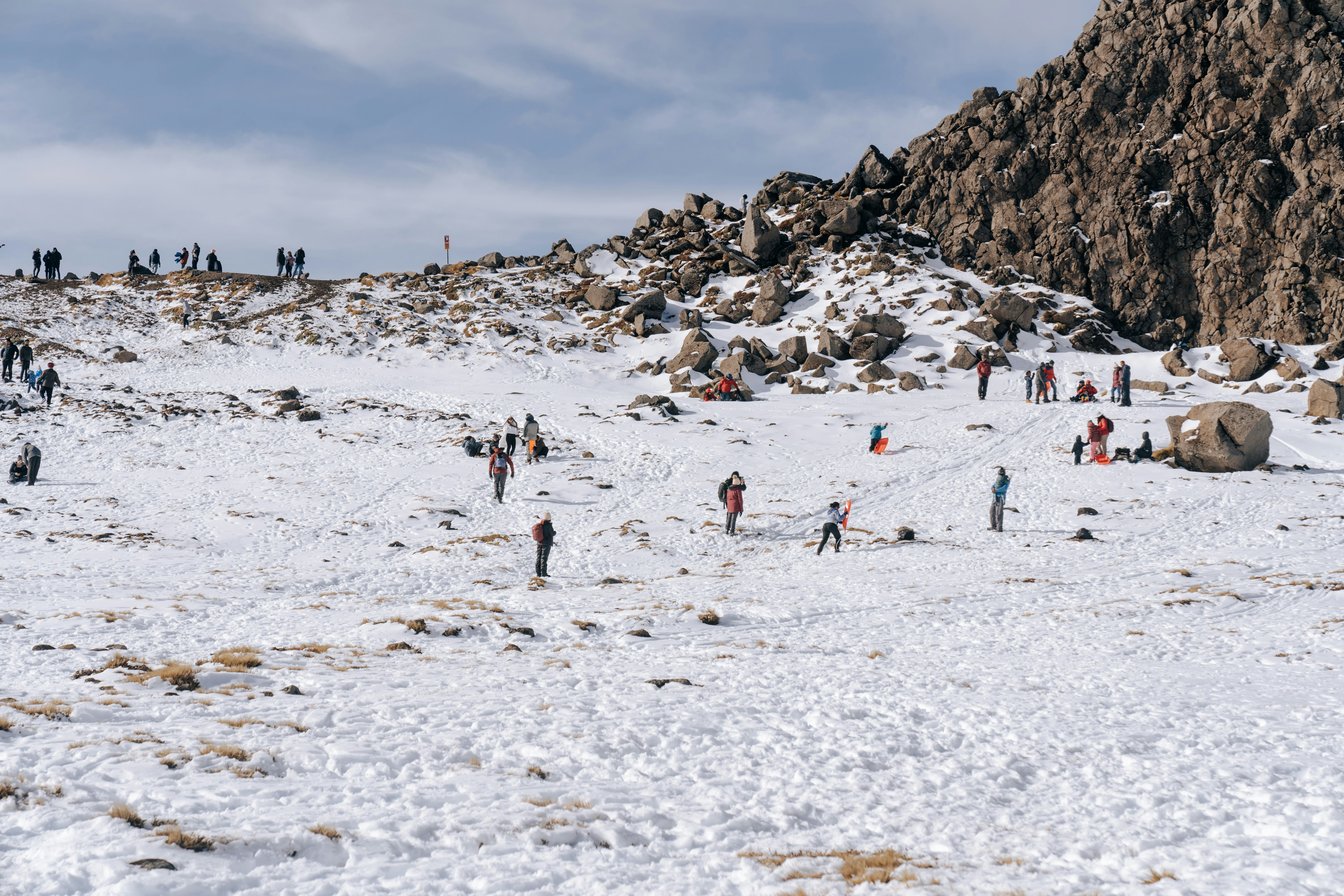 people on snow covered field during daytime