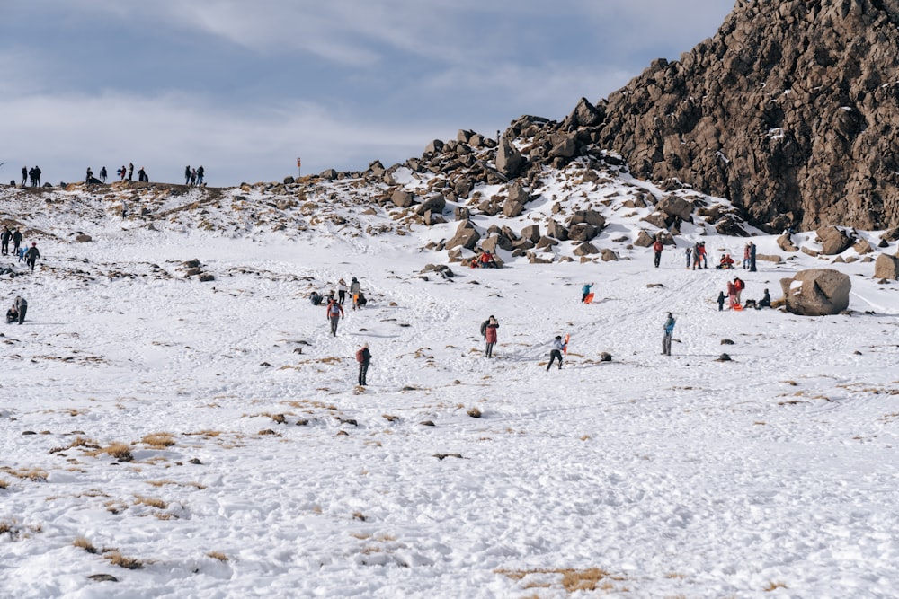 people on snow covered field during daytime