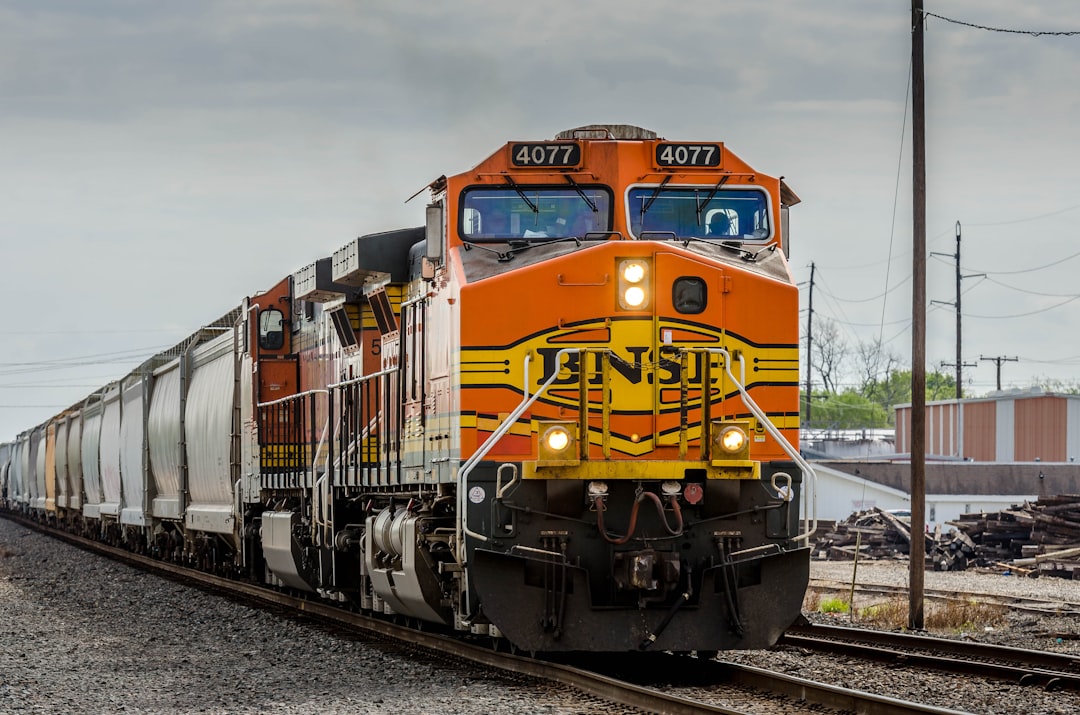 yellow and black train on rail tracks during daytime