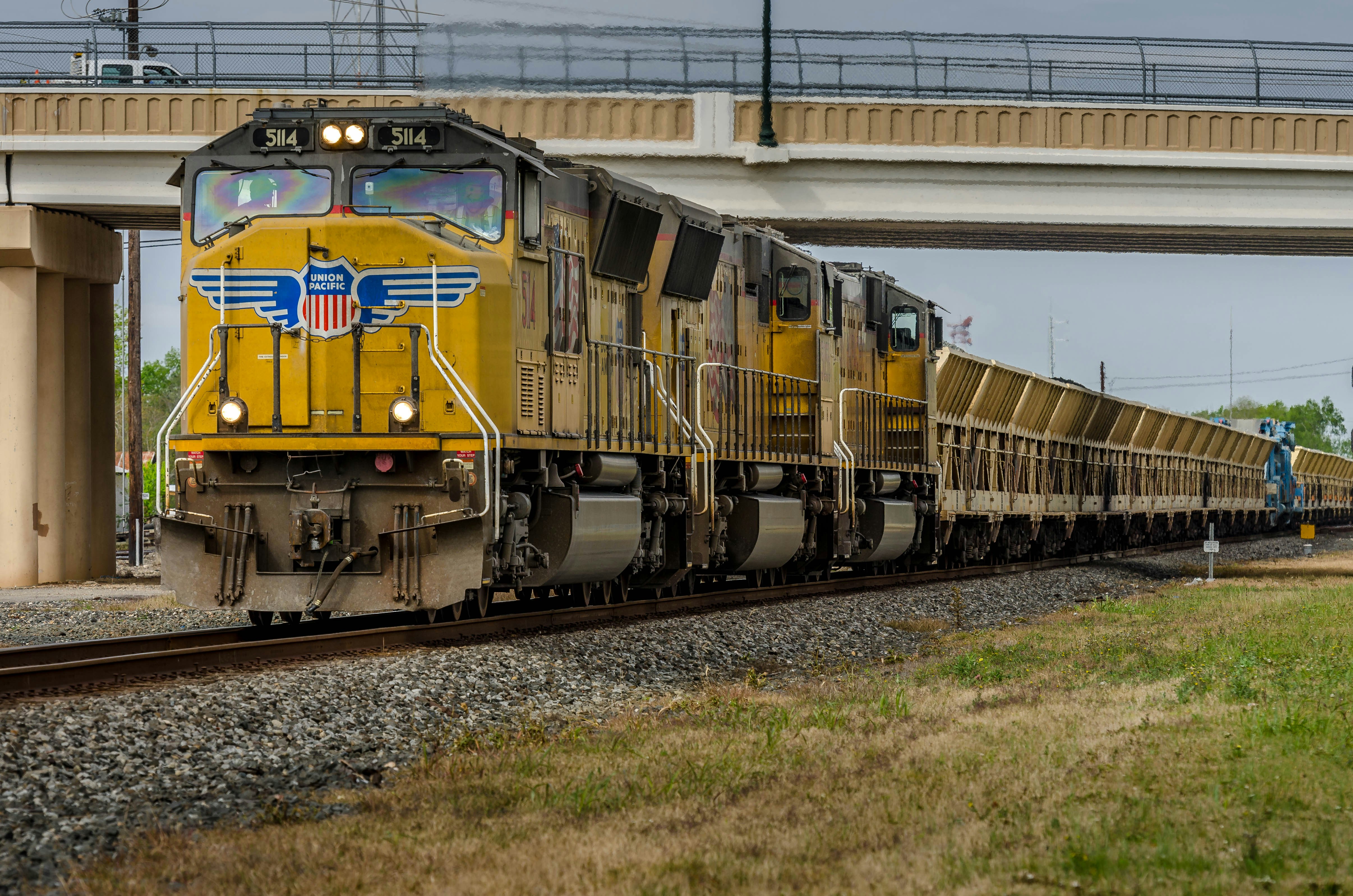 yellow train on rail tracks during daytime