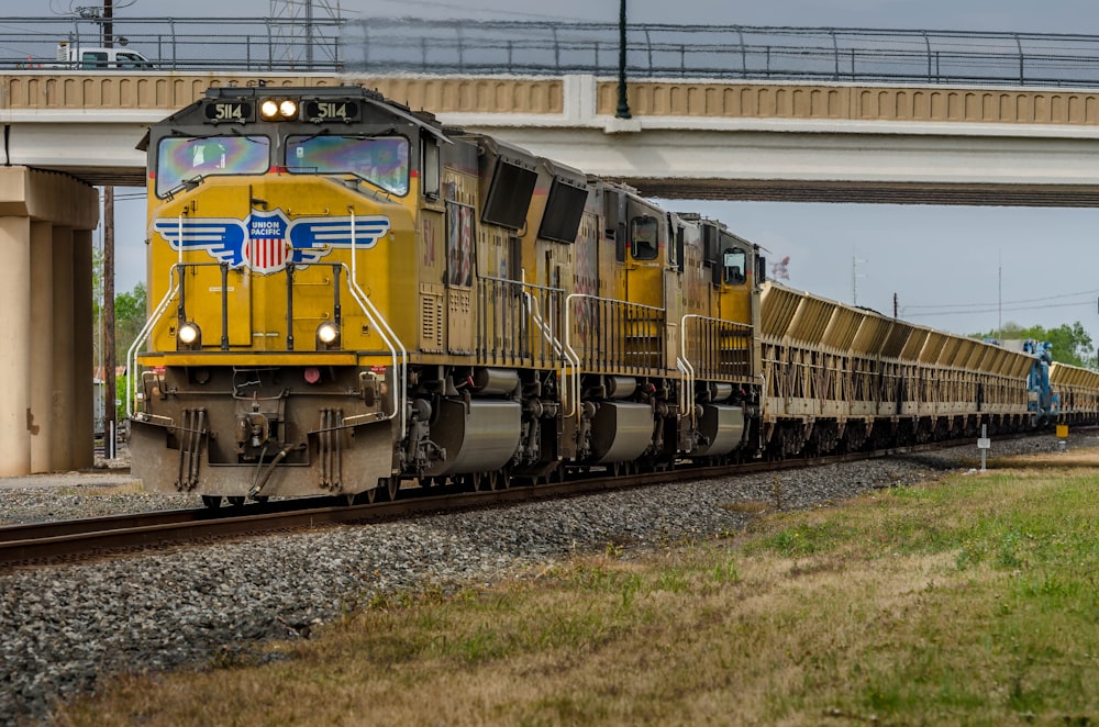 yellow train on rail tracks during daytime