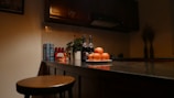 A vibrant kitchen counter displaying dvinex products alongside fresh fruits and a water bottle.