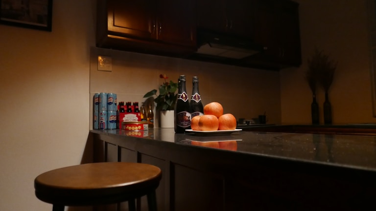 A vibrant kitchen counter displaying dvinex products alongside fresh fruits and a water bottle.
