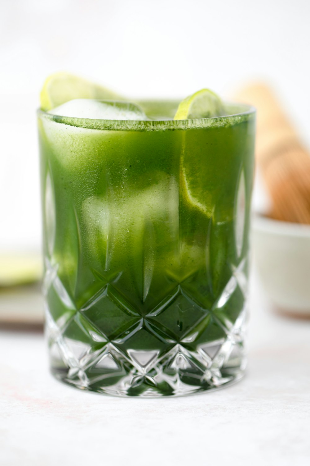 clear drinking glass with green liquid