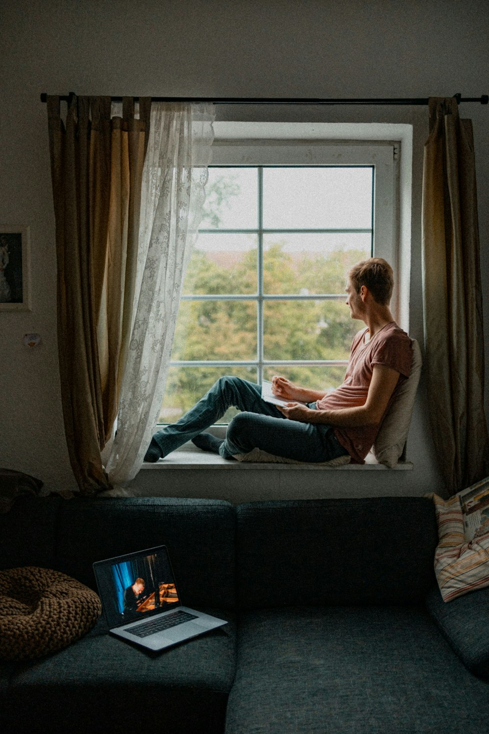 woman in red shirt sitting on couch