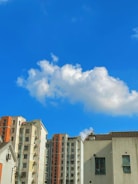 A vibrant cityscape with modern apartment buildings under a clear blue sky.