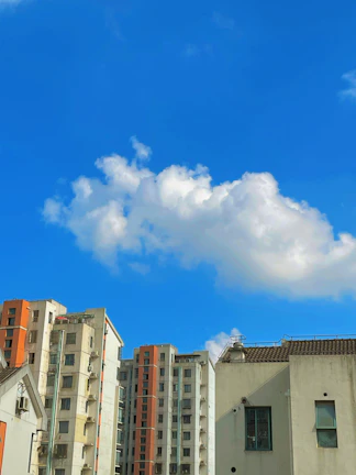 A joyful client holding keys to their first apartment, with a city skyline behind.
