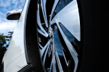 Shiny rims and spotless tires reflecting the blue sky after a thorough mobile cleaning.