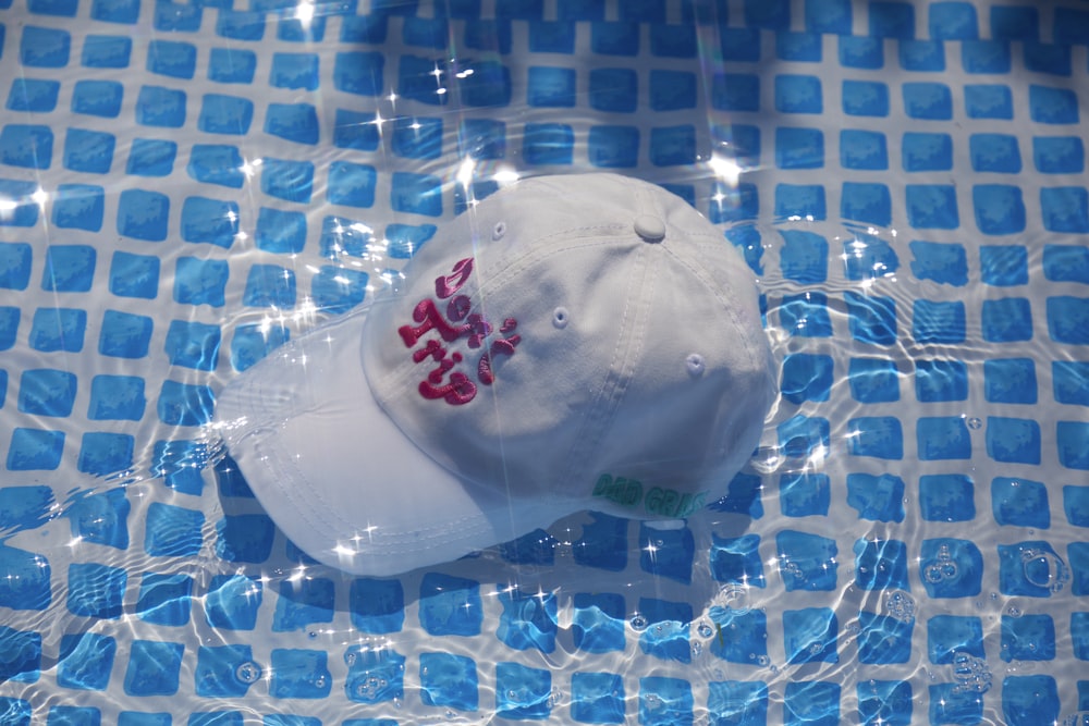 white and red cap on blue surface