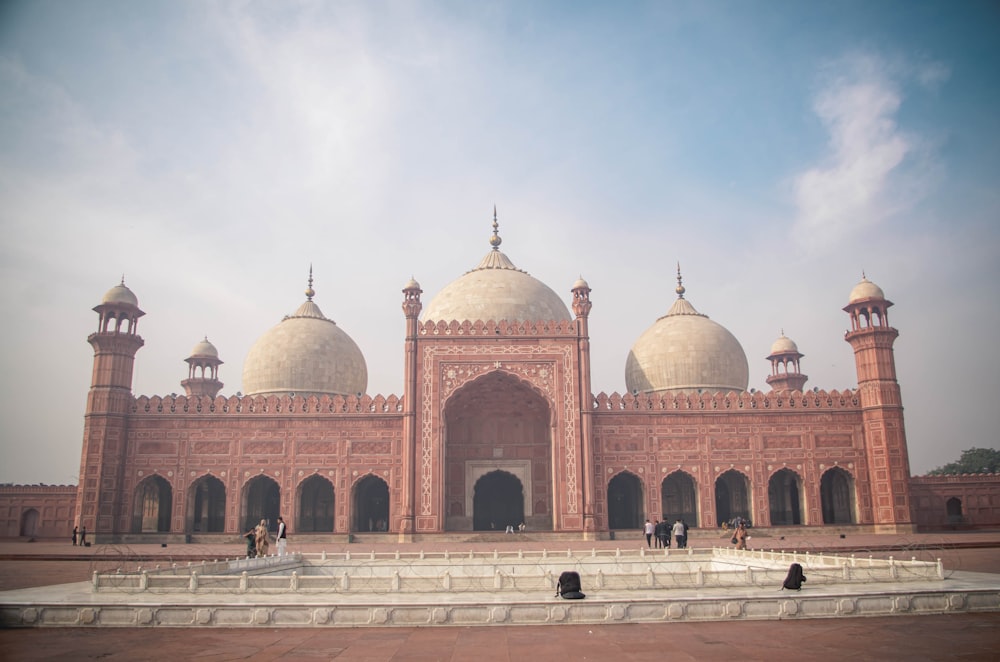 brown and white dome building under white sky during daytime