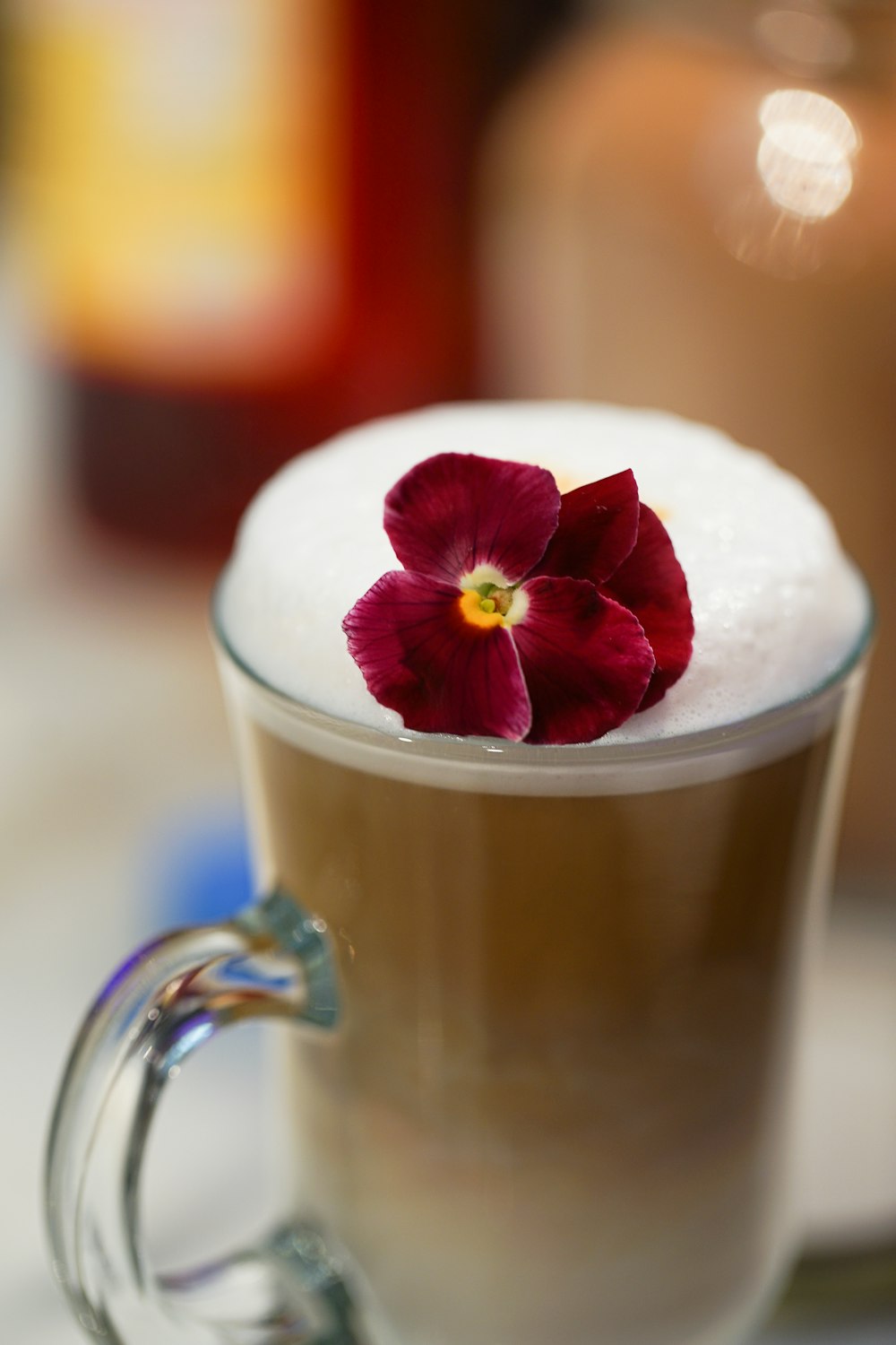 white and red rose in clear glass mug