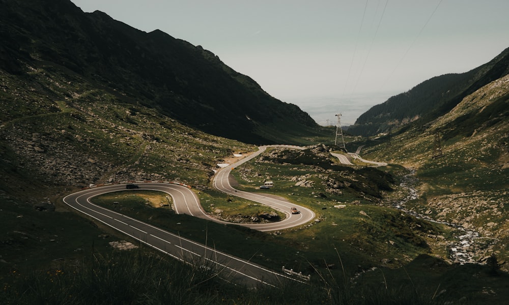 aerial view of highway in between mountains during daytime