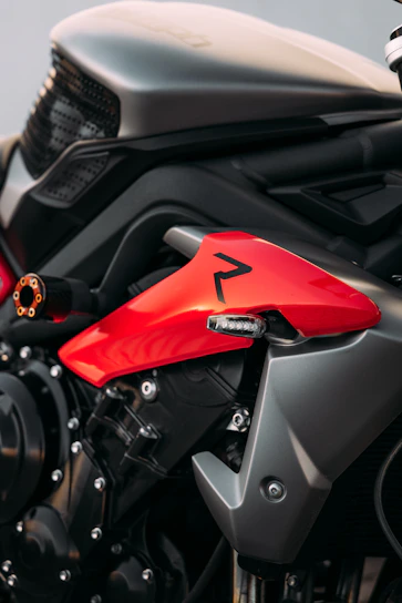 A close-up of a modern electric motorcycle with red accents