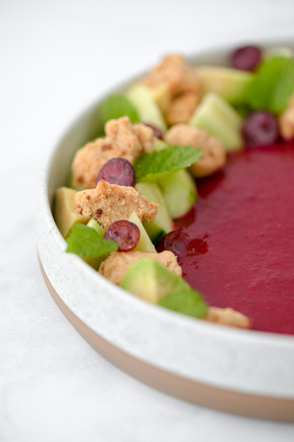 sliced green fruit on white ceramic bowl