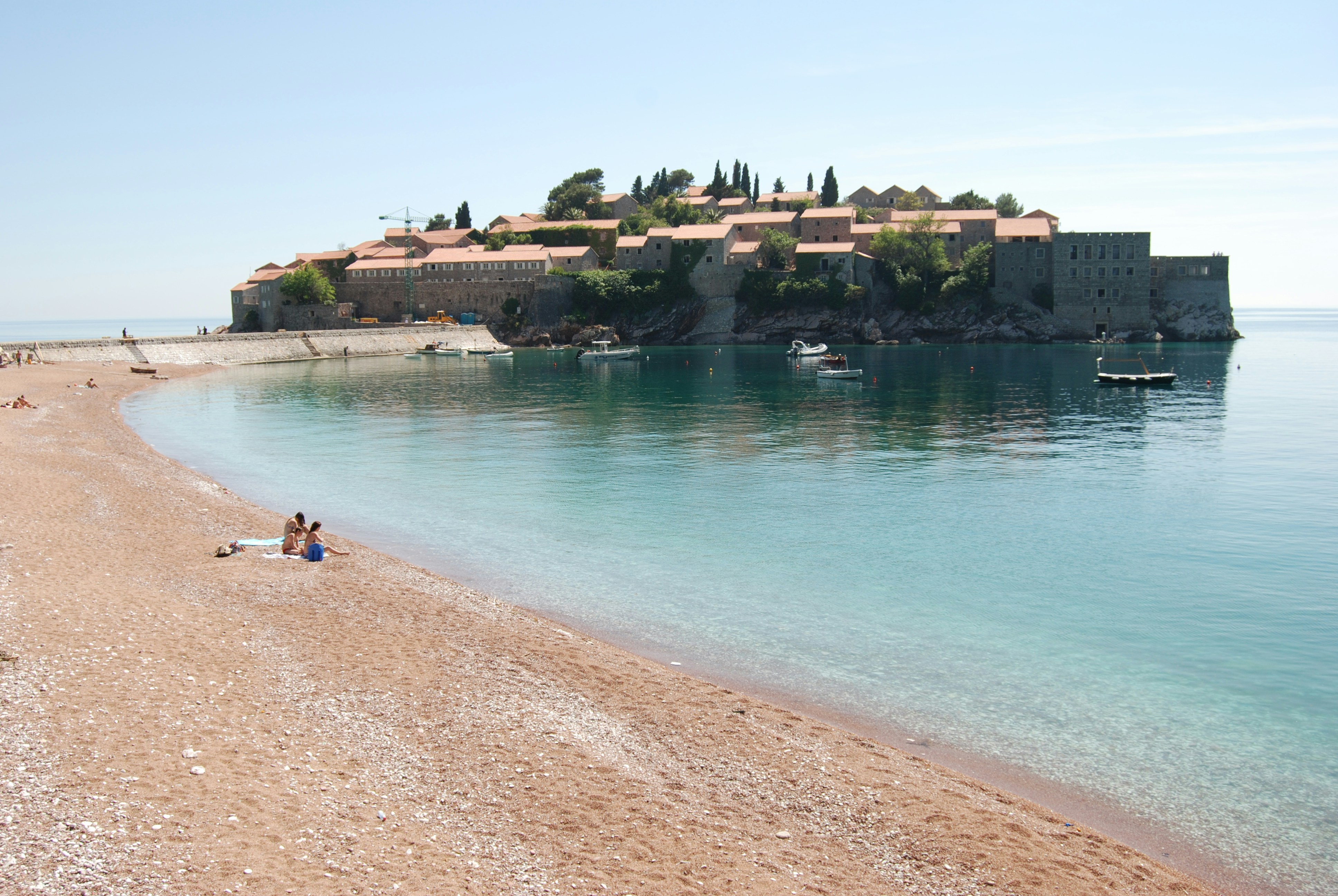 people swimming on beach during daytime