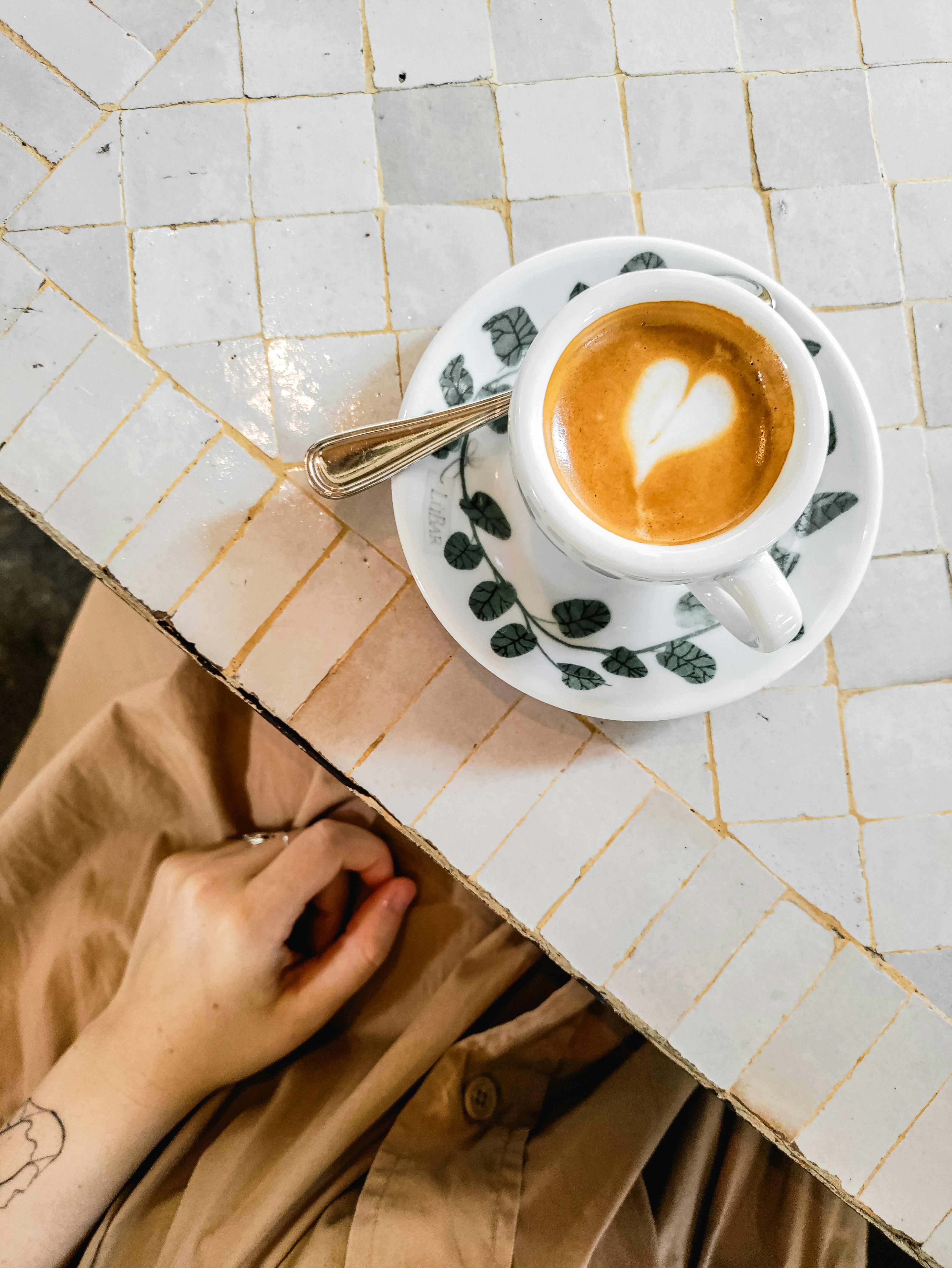 white and black ceramic cup with saucer