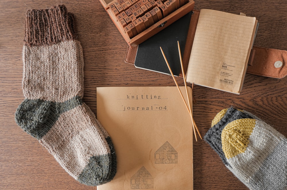 white and blue knit sock beside brown wooden box