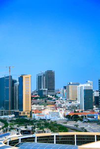 A vibrant cityscape showing cranes and buildings under construction in Navi Mumbai.