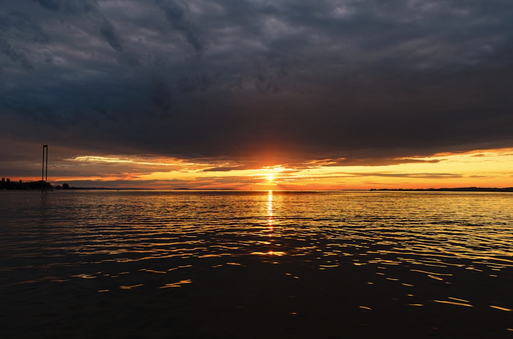 body of water during sunset