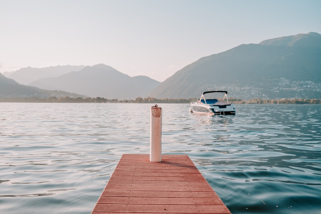 white boat on body of water during daytime