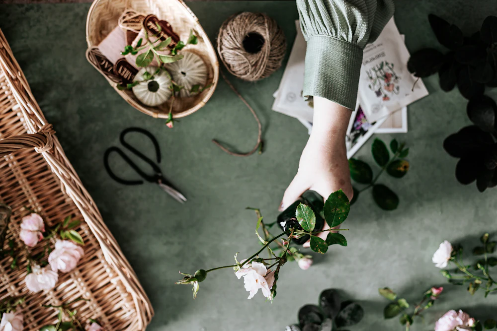 A florist's hands working with stems