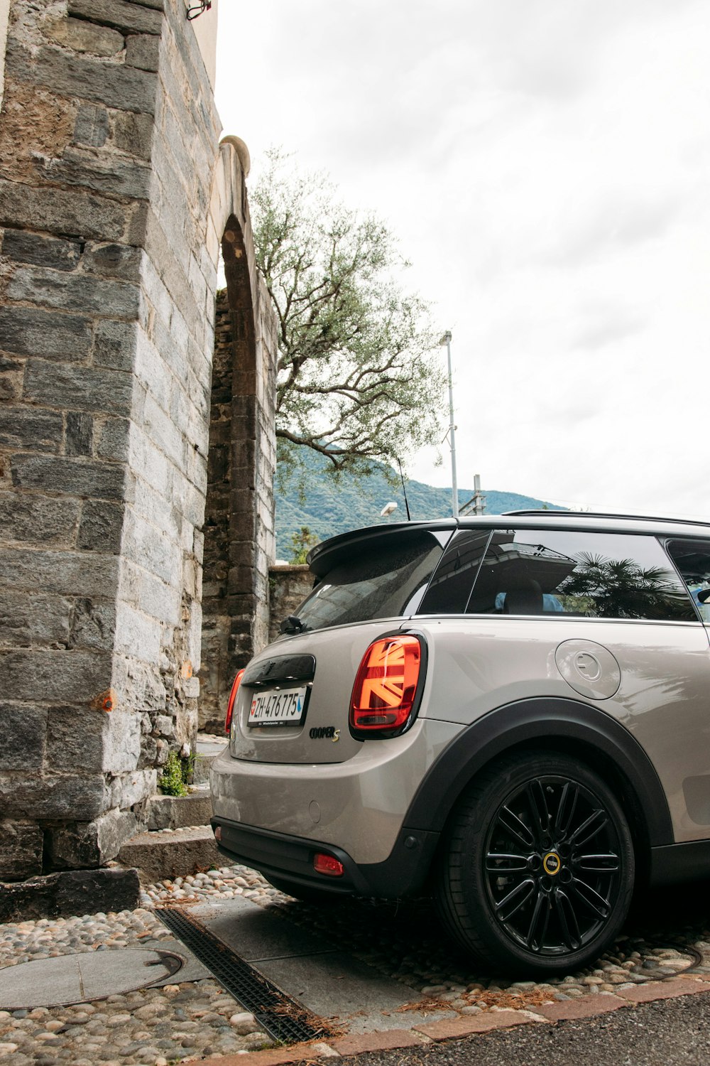 silver suv parked beside brown brick wall