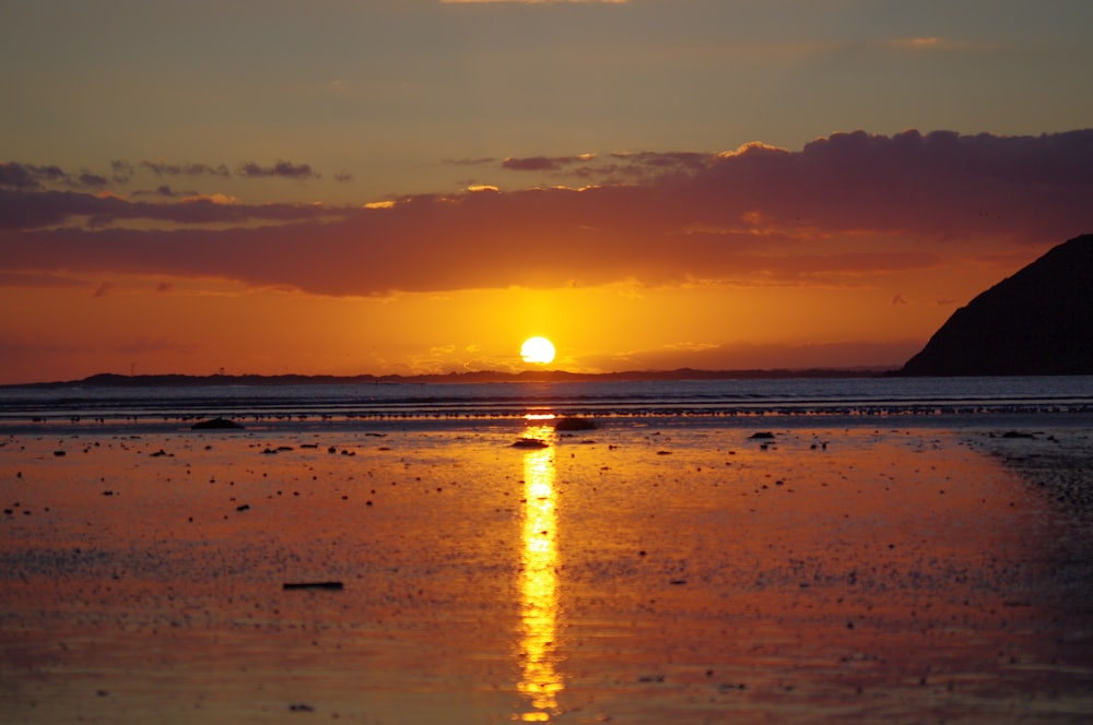 body of water during sunset