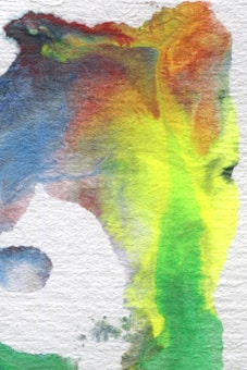 A vibrant abstract watercolor painting featuring fluid transitions between various colors. The image includes shades of blue, red, yellow, green, and hints of purple blending seamlessly together. The texture of the watercolor paper is visible, enhancing the tactile quality of the artwork.