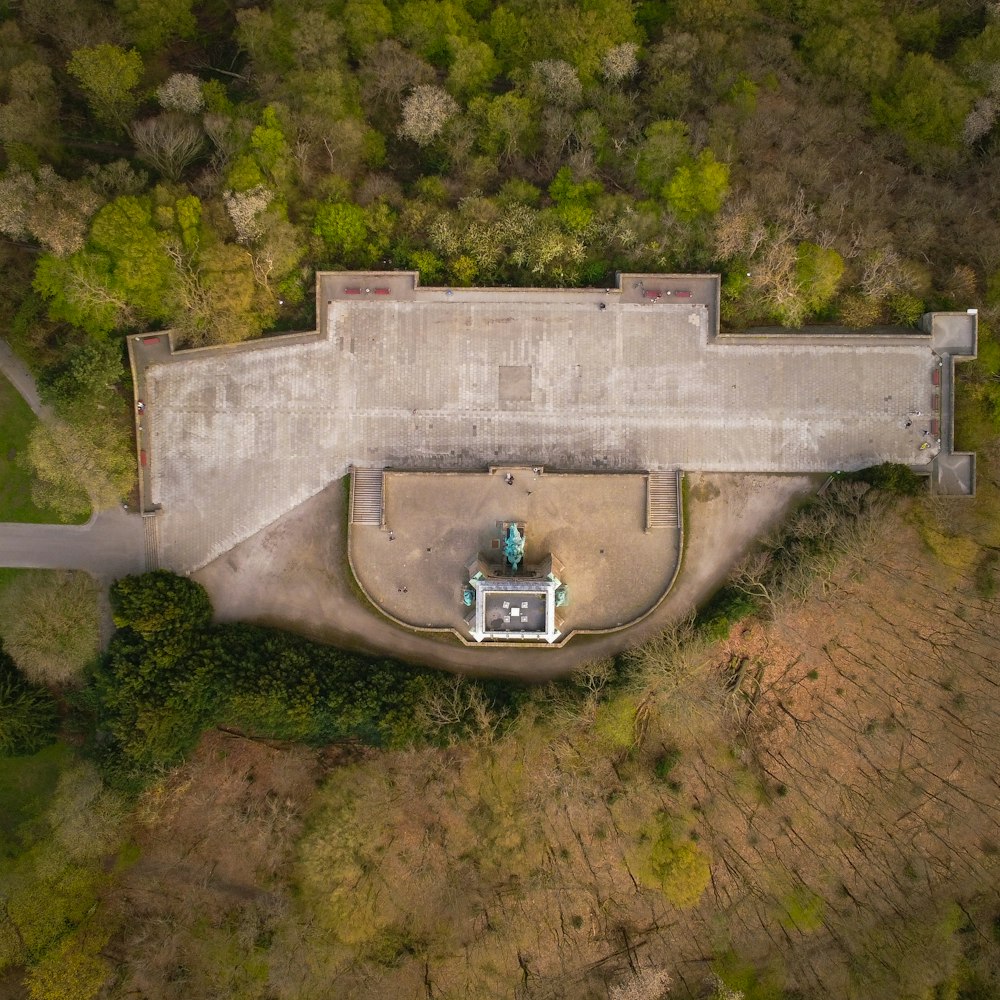 aerial view of green trees and gray concrete bridge