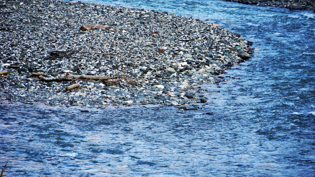 gray and white stones near body of water during daytime