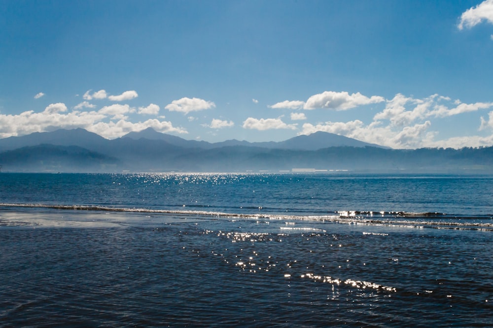 blue sea under blue sky and white clouds during daytime