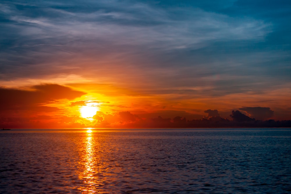 body of water during sunset