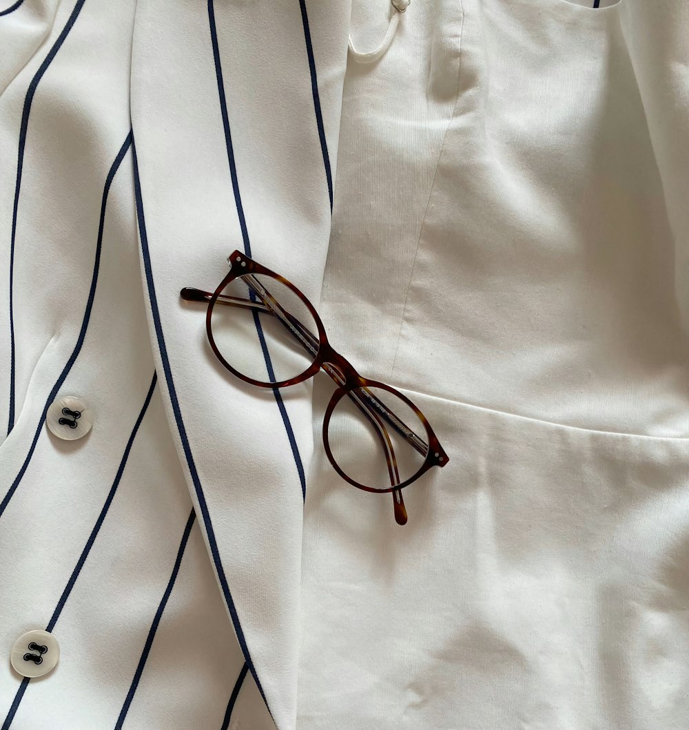 black framed eyeglasses on white textile