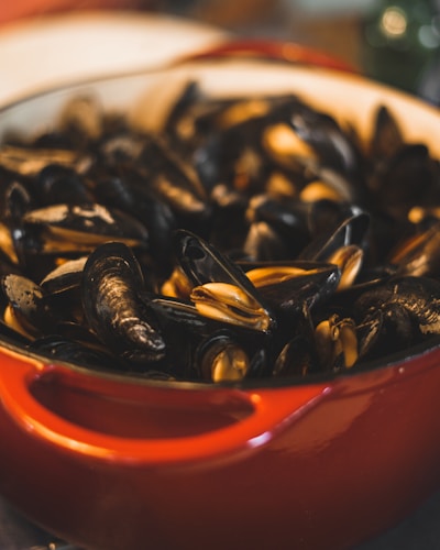 A vibrant display of various mussels sauces in elegant jars.