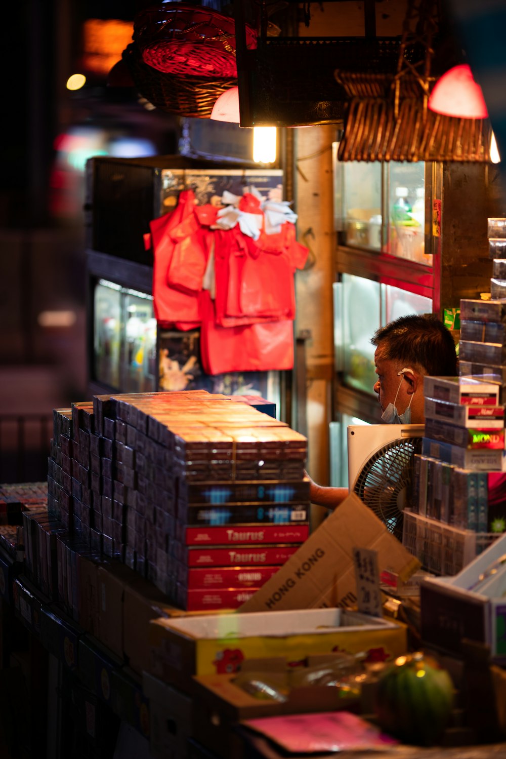 a man sitting in front of a store filled with books