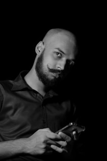 A man proudly showcasing his mustache for Movember.