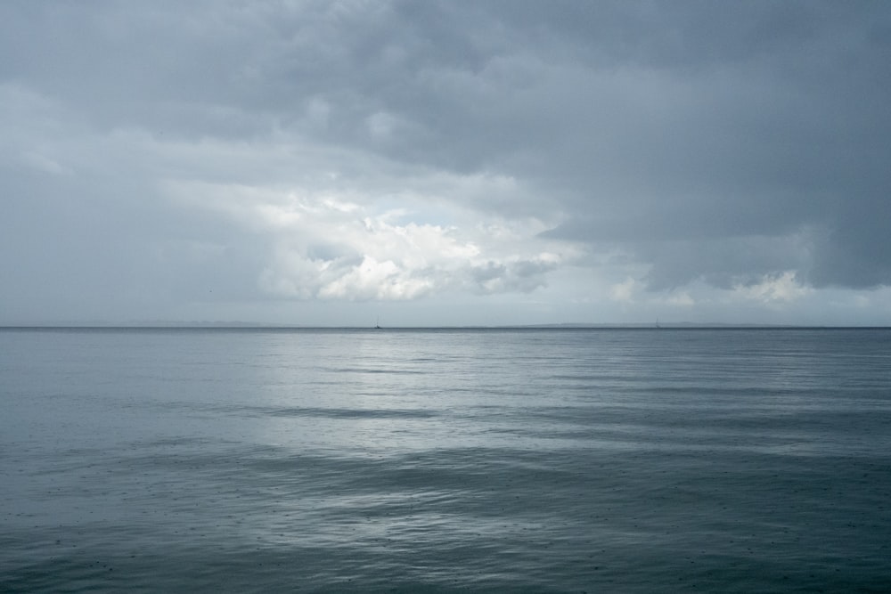 body of water under cloudy sky during daytime