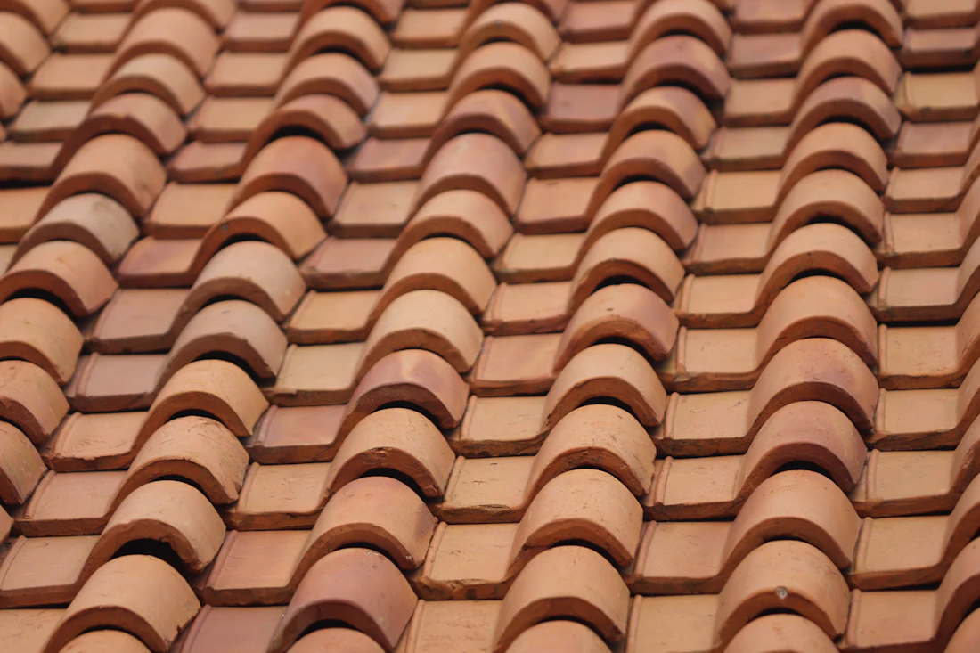 Close-up of overlapping brown and white roof tiles
