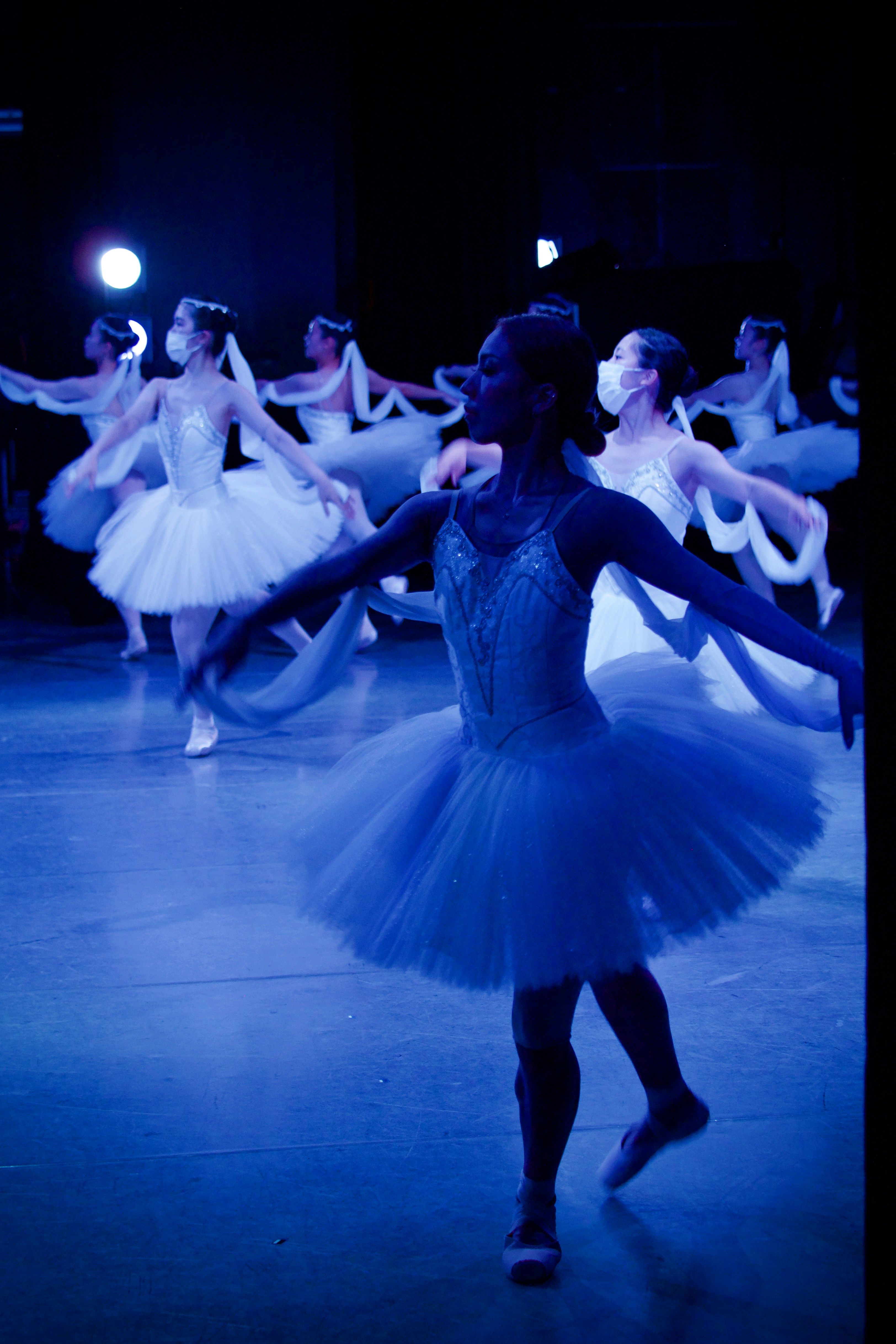 woman in white dress dancing on stage