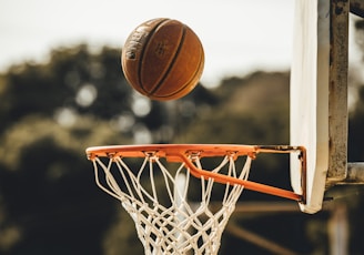 brown basketball on basketball hoop