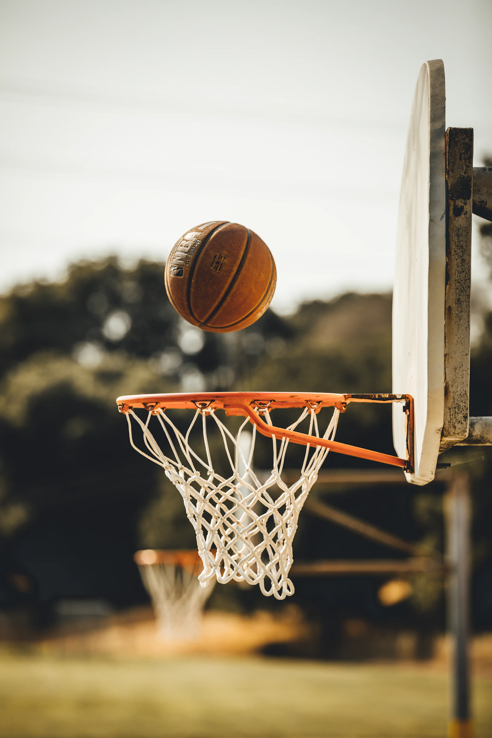 Basketball dropping through a hoop