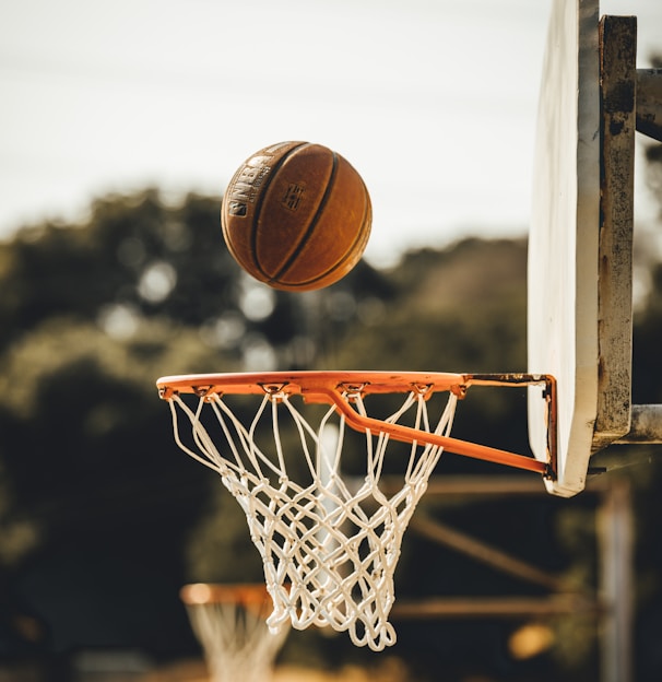 brown basketball on basketball hoop