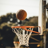 brown basketball on basketball hoop