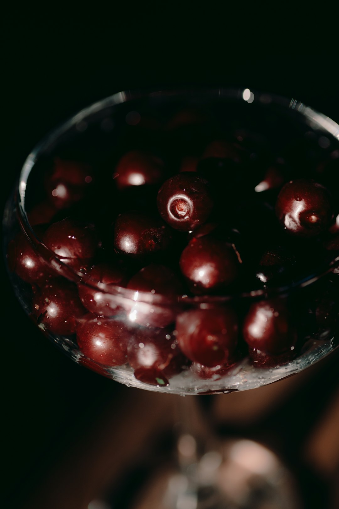 red cherries in clear glass bowl